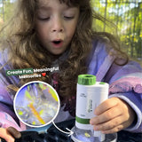 Child holding a white and greenMiniscope with colorful liquid inside, outdoors.